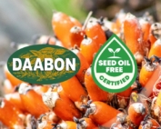 A close-up of fresh red palm fruit with the DAABON logo and the Seed Oil Free Certified seal overlaid.