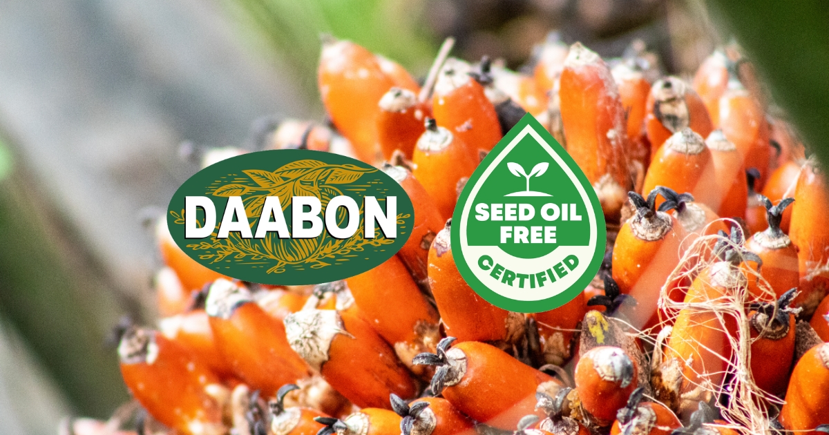 A close-up of fresh red palm fruit with the DAABON logo and the Seed Oil Free Certified seal overlaid.
