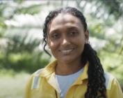 Female palm oil worker in sustainable plantation representing women in sustainable agriculture